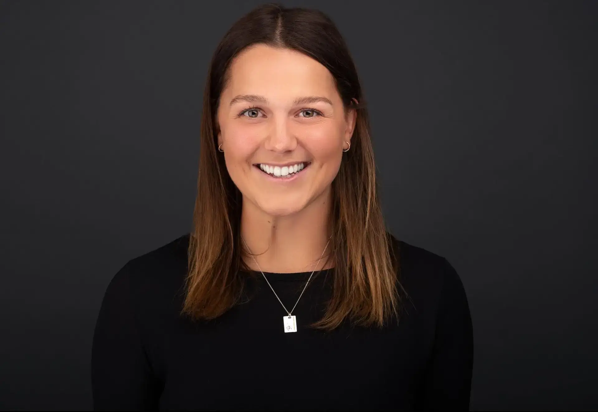 Corporate headshot Sydney, woman on dark background